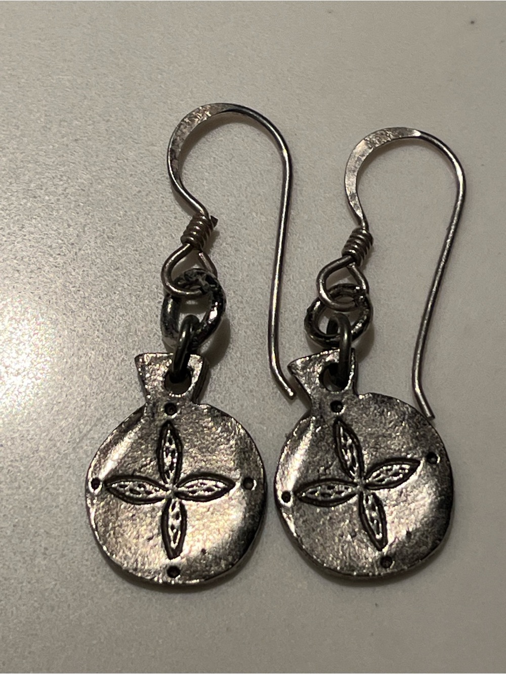 Lovely sterling silver wire earrings with flower on front.